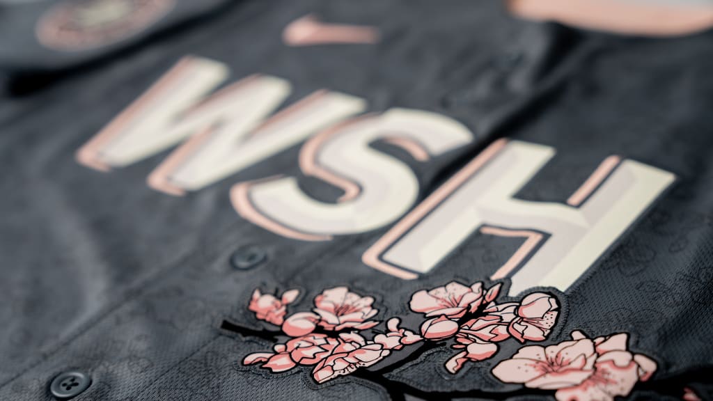 Real men wear pink'  Nats fans line up to buy cherry blossom uniforms 