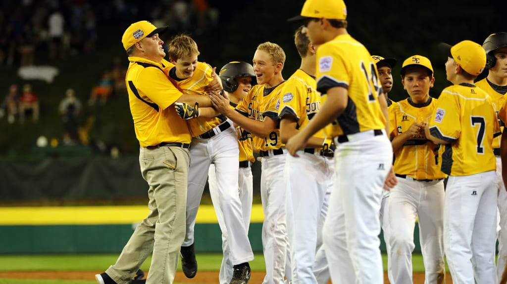 Teammates swarm Tennessee's Robert Carroll after he hit a walk-off two-run double to defeat Oregon. (Photo by Alex Trautwig/MLB Photos)