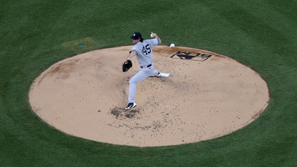 From a bird’s-eye view, it was easy to see how bizarre it was to play baseball in 2020. But zoomed in, the game looked incredibly familiar. Yankees fans who had waited months to see Gerrit Cole take the mound also thrilled at Giancarlo Stanton’s remarkable moonshot on Opening Day. (Credit: Triumph Books)