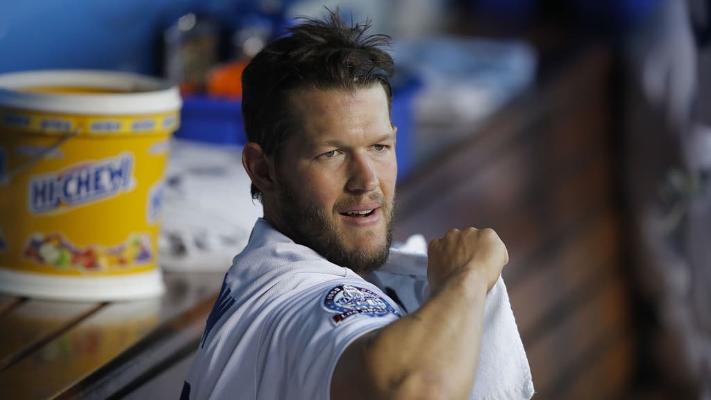 Los Angeles Dodgers starting pitcher Clayton Kershaw wraps his shoulder with a towel before the team's baseball game against the Washington Nationals, Friday, April 20, 2018, in Los Angeles. (AP Photo/Jae C. Hong)