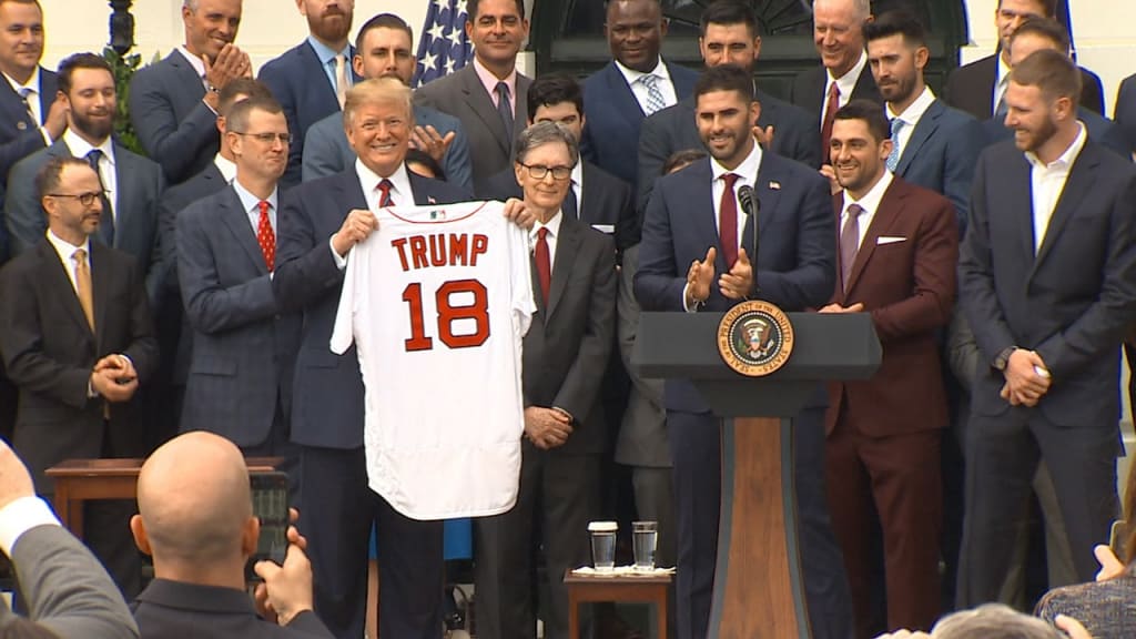 President Donald Trump is presented with a Boston Red Sox baseball team  jersey by Red Sox outfielder J. D. Martinez, during a ceremony on the South  Lawn of the White House in