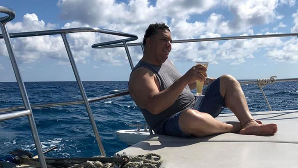 Bartolo Colon relaxed on a boat with a beer
