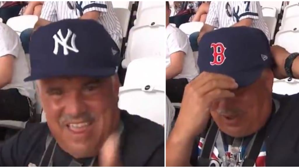 Fan wears Yankees and Red Sox hat in London