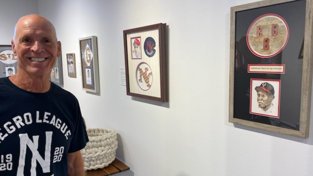 Tom Runnells surrounded by his work