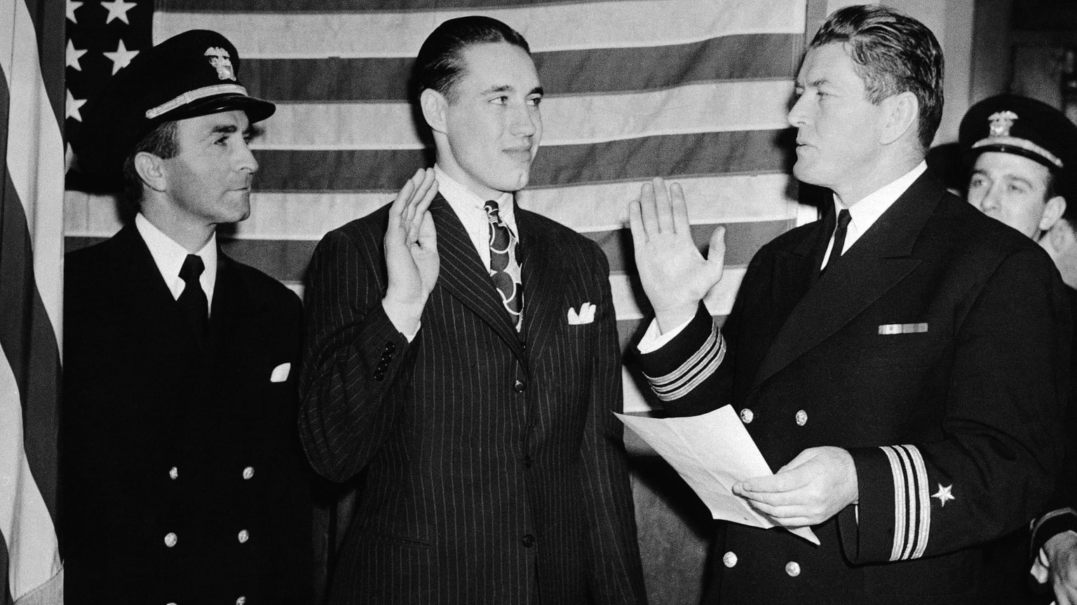 Bob Feller takes an oath as he enlists in the Navy
