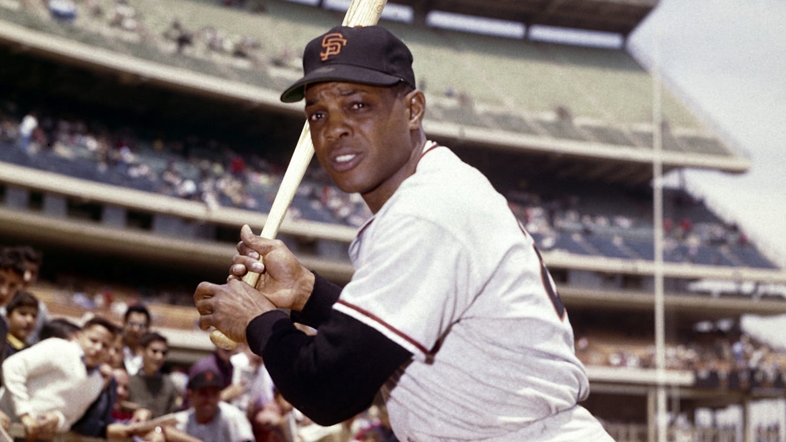 Willie Mays poses with a bat before a game
