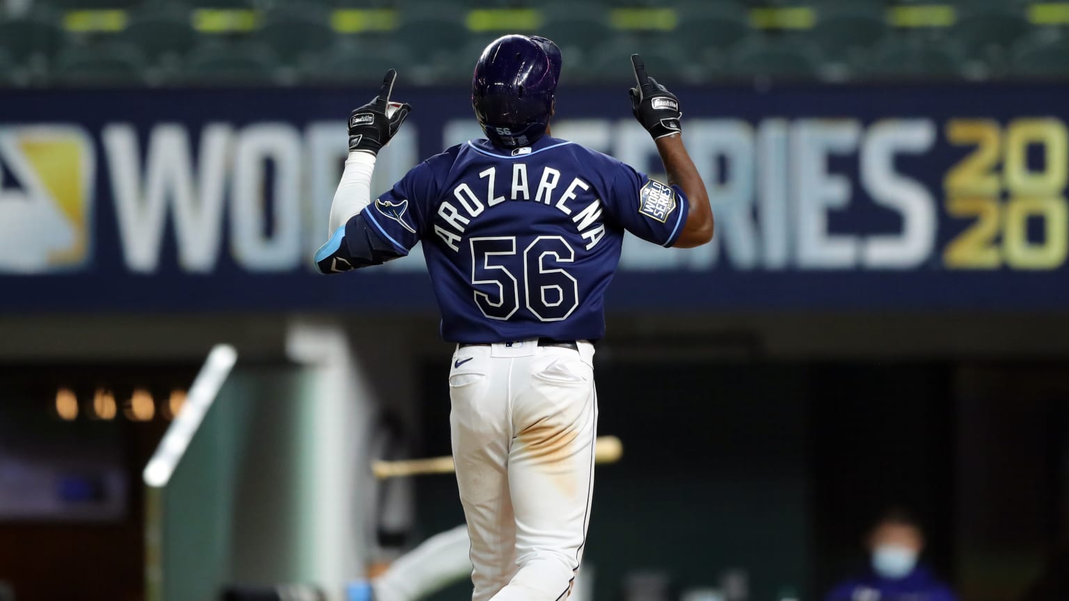 Randy Arozarena points to the sky after hitting a home run.