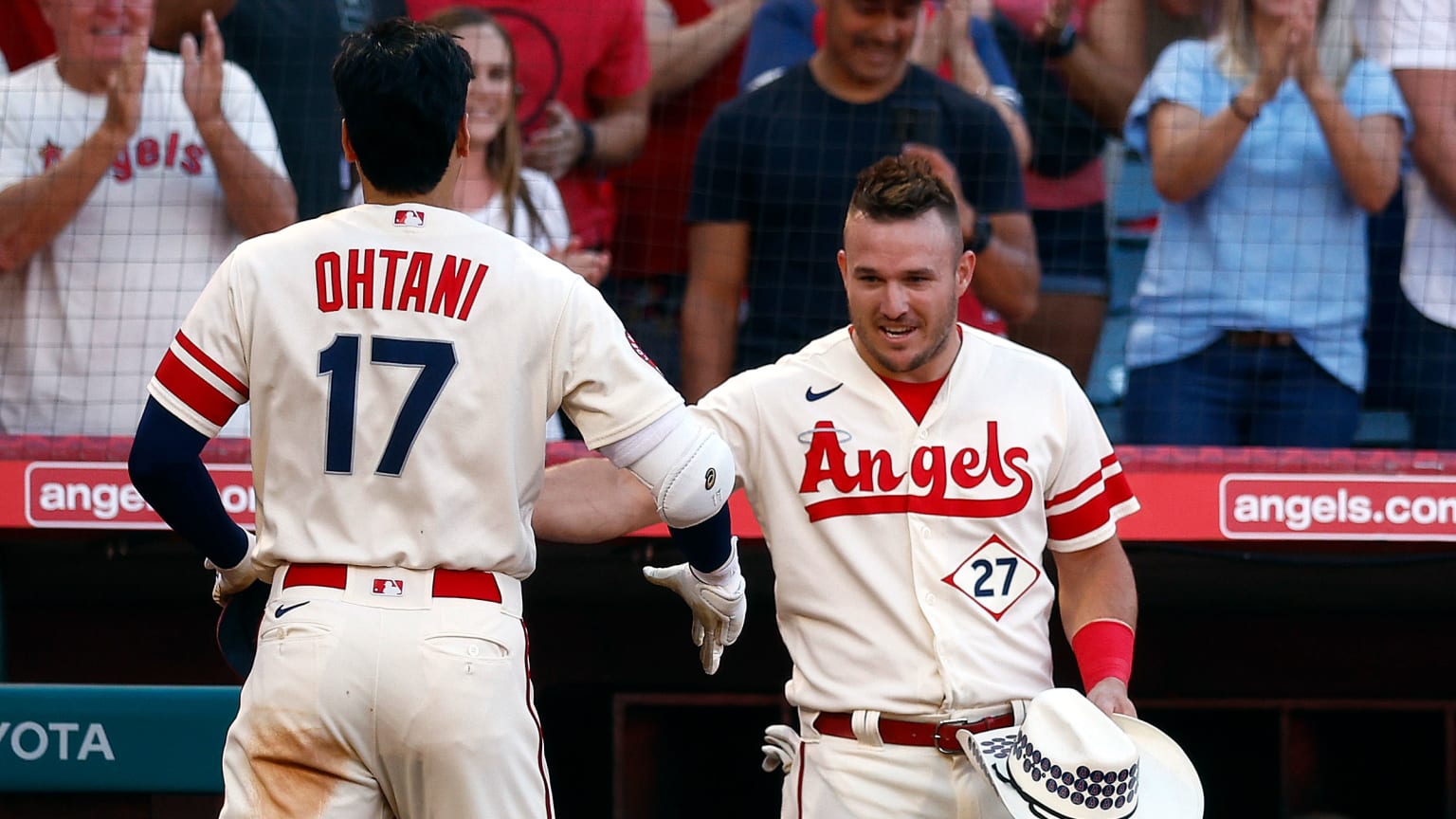 Mike Trout greets Shohei Ohtani in the dugout