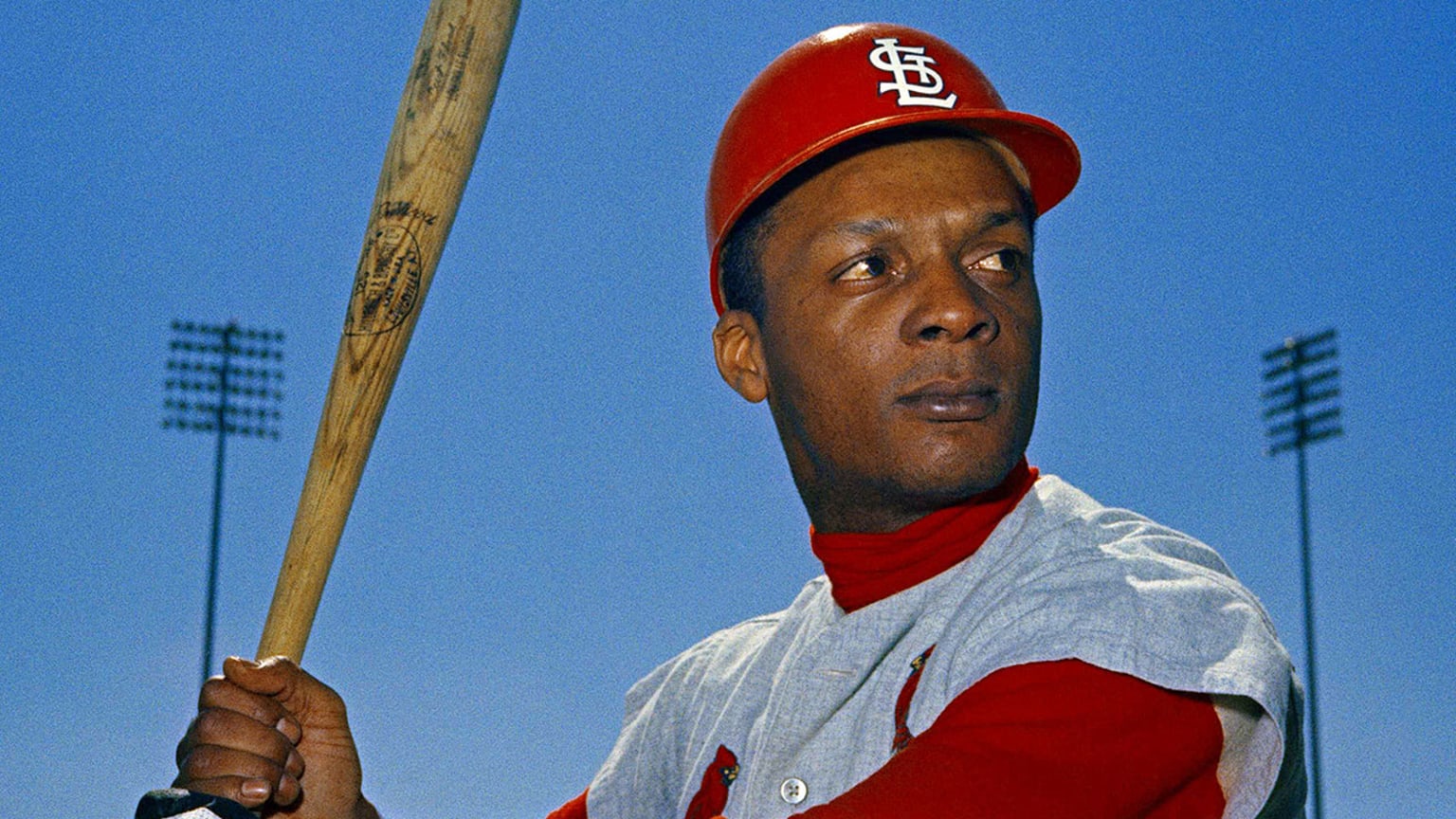 Curt Flood poses with a bat in a Cardinals road uniform