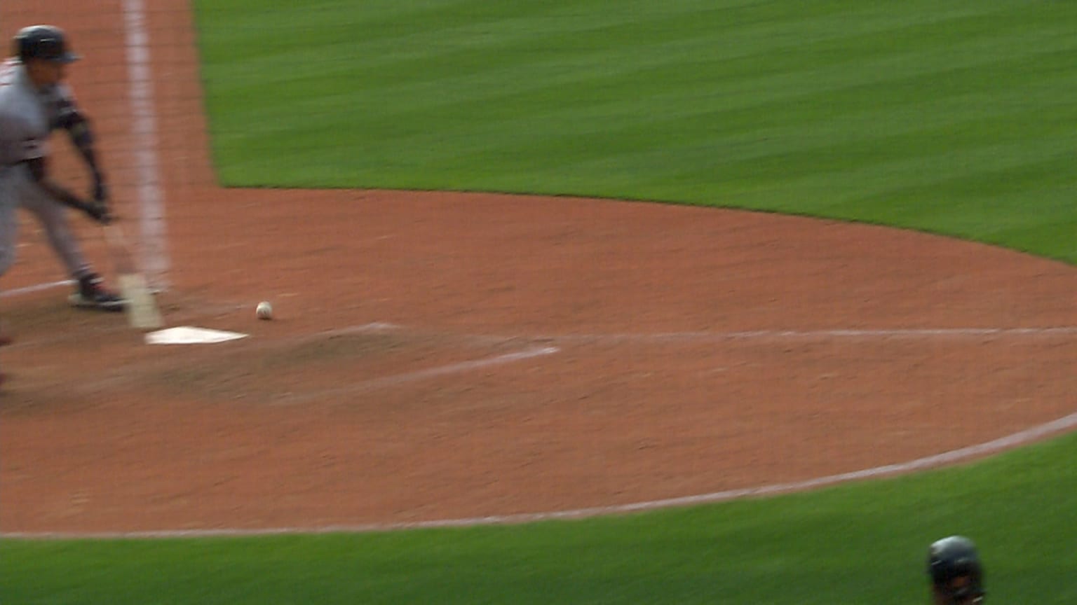 A screenshot of the baseball hitting the dirt in front of home plate, with the batter mid-swing