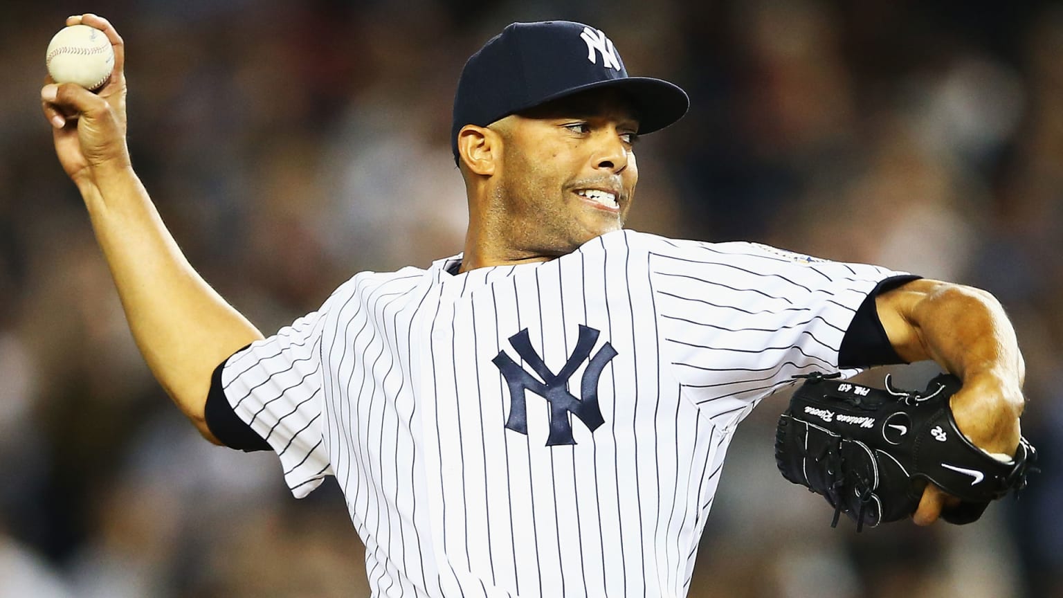 Mariano Rivera throws a pitch while wearing the Yankees home uniform