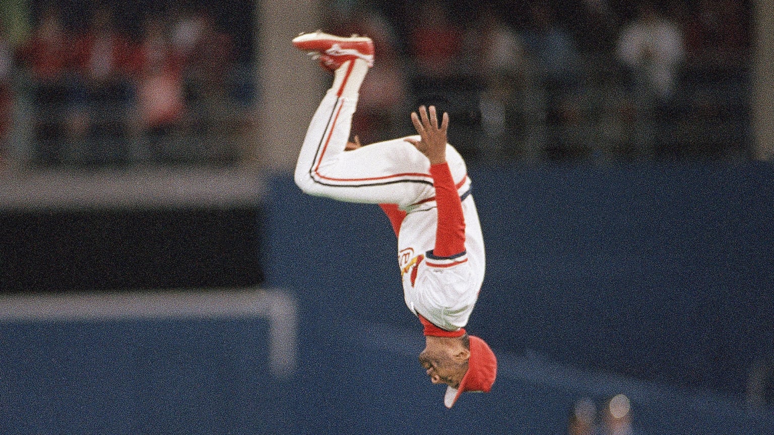 A photo of Ozzie Smith upside down in midair during one of his patented backflips