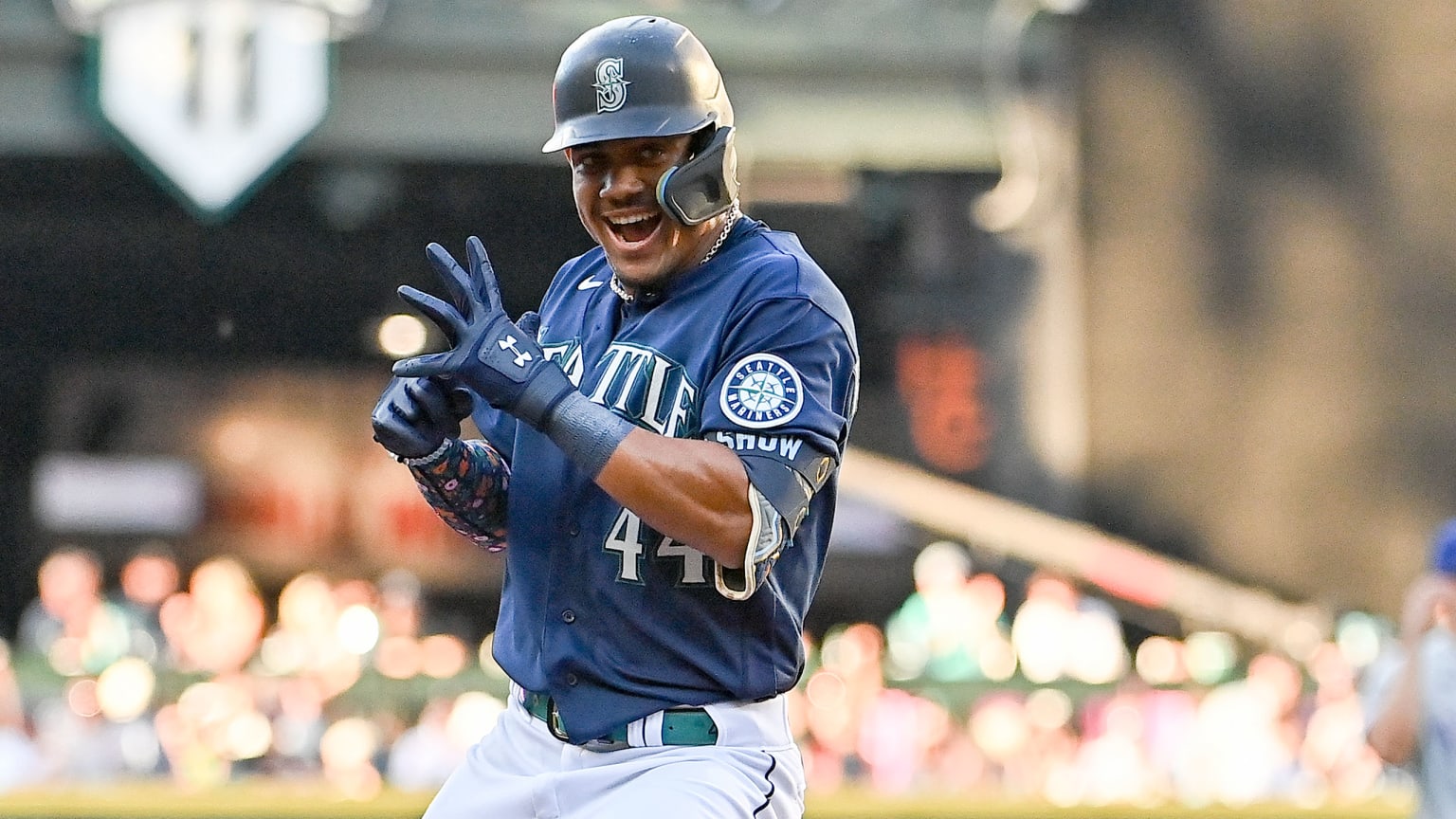 Julio Rodriguez smiles and styles as he rounds third base on a home run