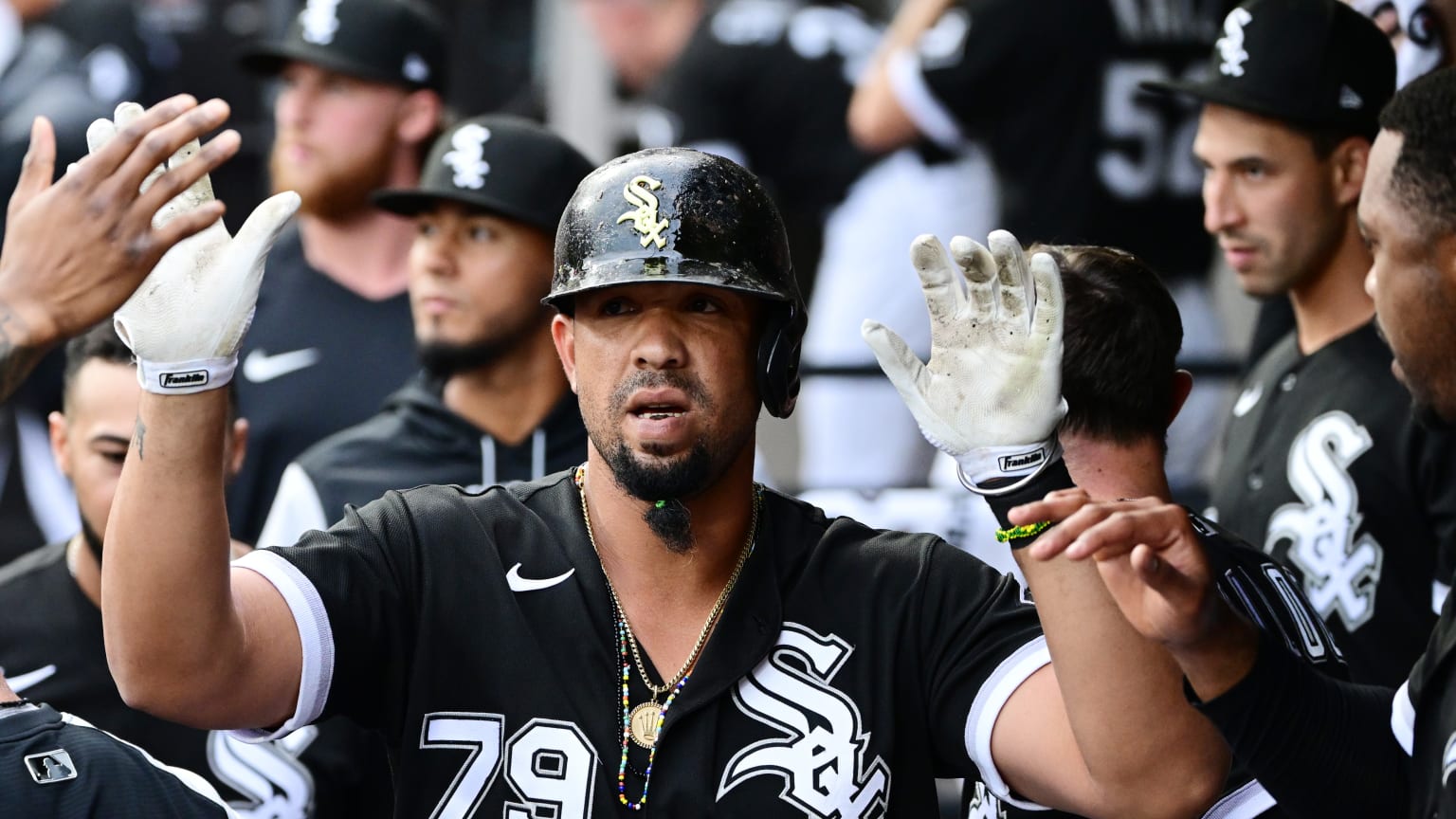 Jose Abreu receives high-fives in the White Sox dugout