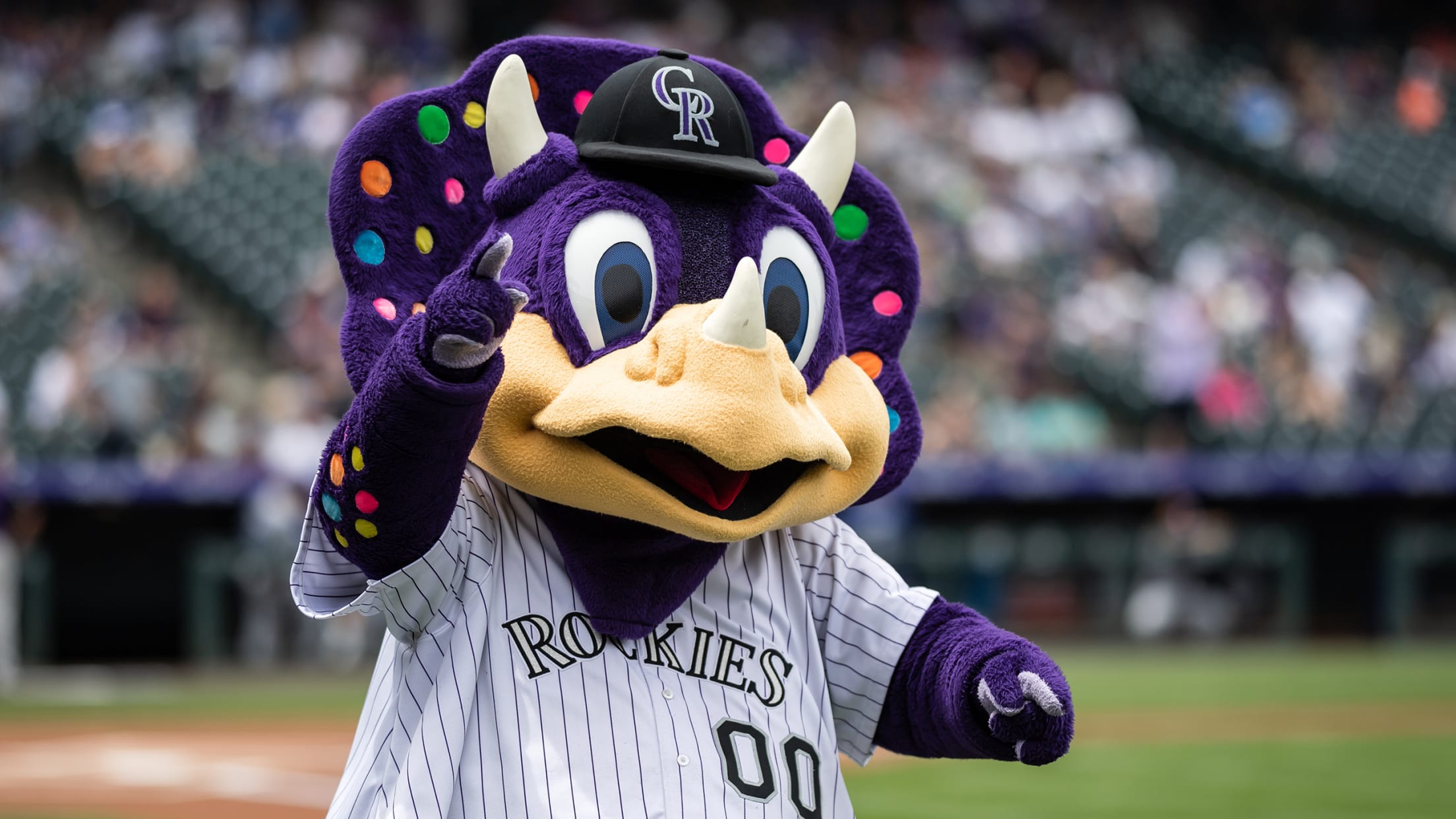 Colorado Rockies mascot dinger the dinosaur in the first inning of