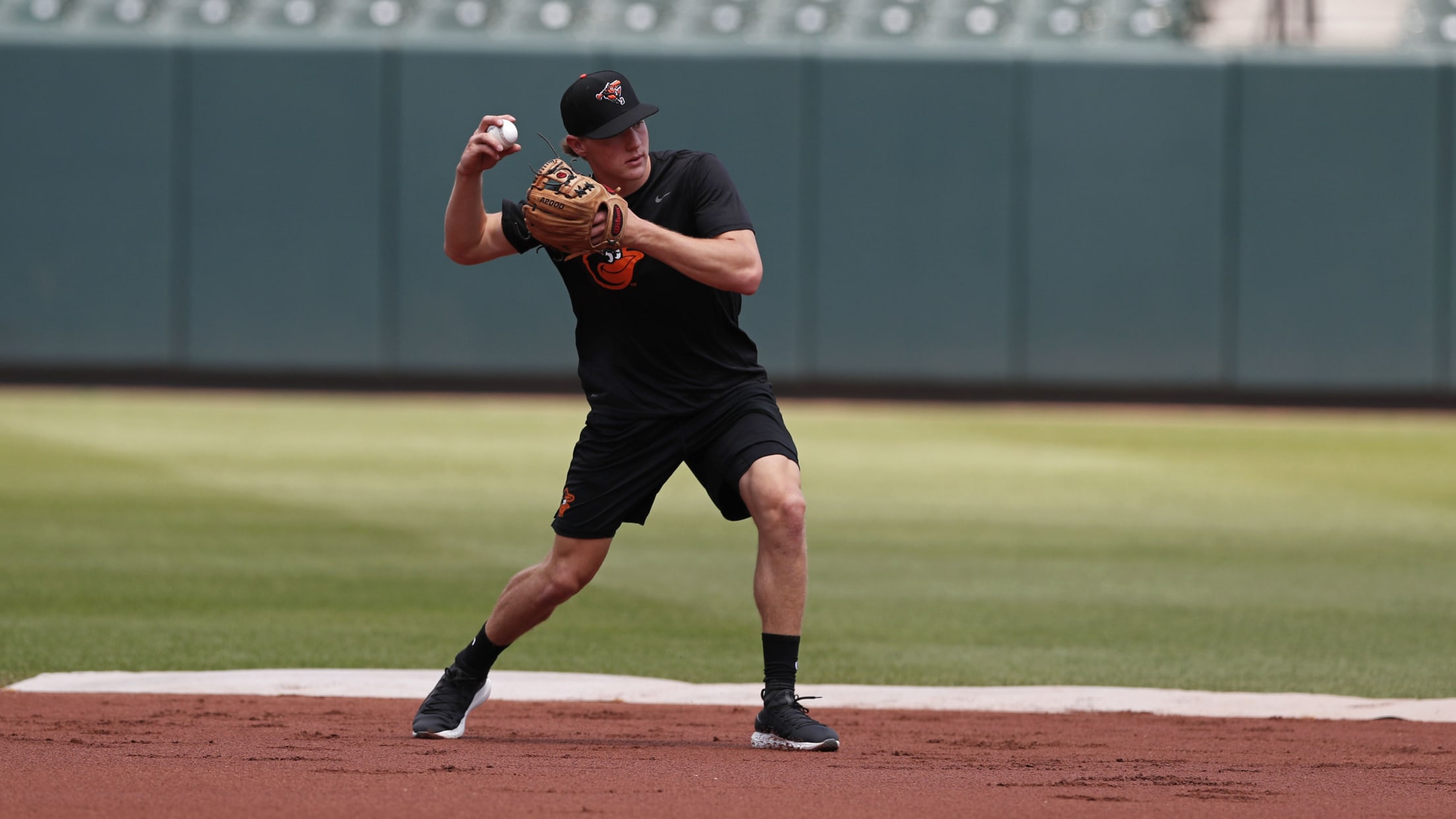 Gunnar Henderson Baltimore Orioles Unsigned White Jersey Swing Photograph