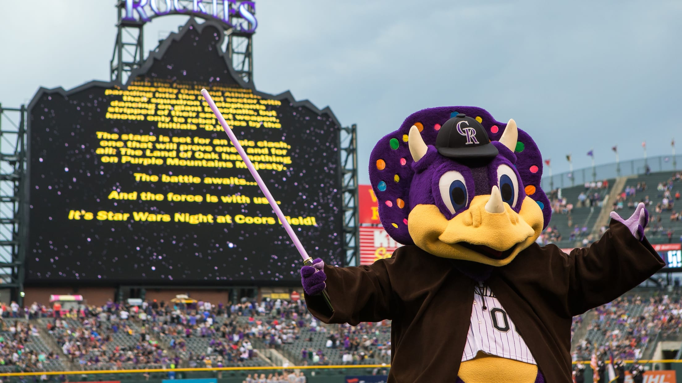 Colorado Rockies mascot Dinger performs in a Star Wars-themed robe