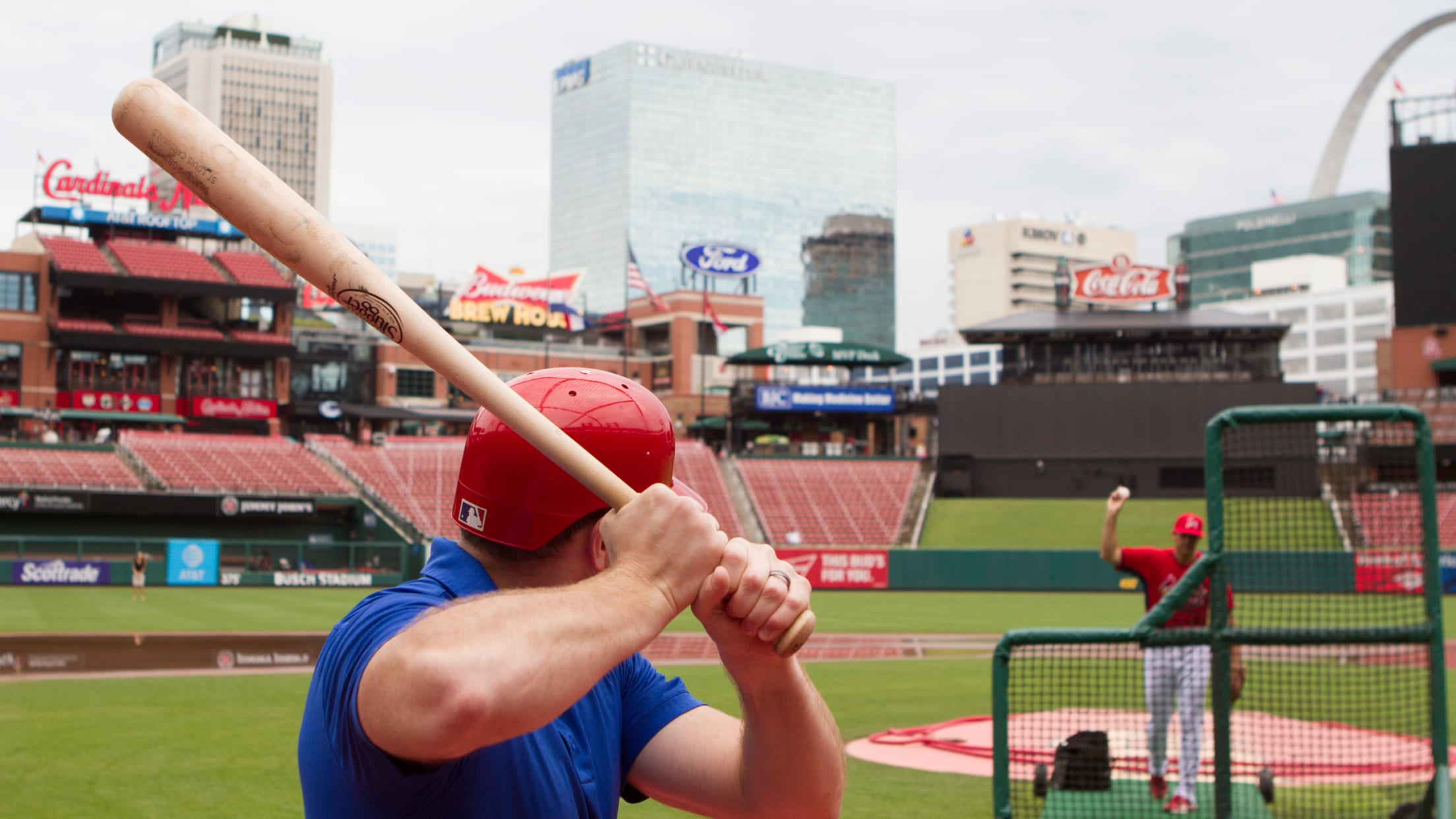 St. Louis Cardinals players and coaches watch batting practice wearing St.  Louis Blues sweaters before a game against the Cincinnati Reds at Busch  Stadium in St. Louis on September 28, 2016. The