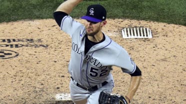 Colorado Rockies relief pitcher Daniel Bard left fielder Connor Joe (9) and  catcher Elias Diaz at the end of a baseball game against the Chicago Cubs  in Chicago, Sunday, Sept. 18, 2022. (