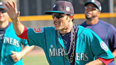 A gold Florida necklace sits over the Mariners logo on the jersey