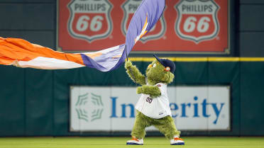 Astros Mascot,Orbit holding a flag while standing on - Depop