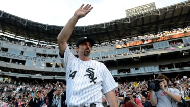 Chicago White Sox designated hitter Paul Konerko (14) gives his wife,  Jennifer, a kiss during his retirement ceremony as the team plays host to  the Kansas City Royals at U.S. Cellular Field