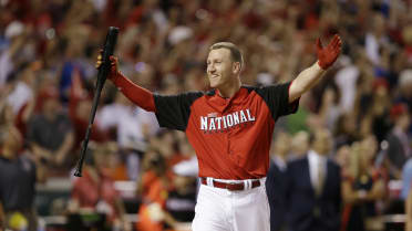 National League's Todd Frazier holds up the Home Run Derby trophy after  defeating Joc Pederson in the Home Run Derby during the 86th All-Star Game  at Great American Ball Park in Cincinnati