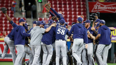 Milwaukee Brewers' Keston Hiura, center, celebrates his run scored against  the Arizona Diamondbacks with teammates Christian Yelich, right, and Brent  Suter, left, during the eighth inning of a baseball game Sunday, July