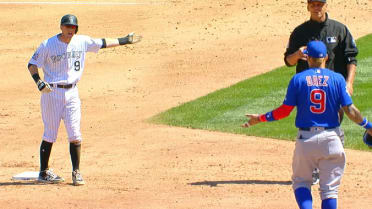 Chicago Cubs' Javier Baez, left, slides into second base safely as he hit a  one-run double as Colorado Rockies second baseman DJ LeMahieu (9) makes a  late tag during the eighth inning