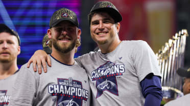 Atlanta Braves' Luke Jackson Cuddles Baby During World Series Game 3