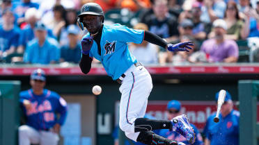 Miami Marlins Juan Pierre (9) takes a bunt against the New York Mets during  a spring training game at the Roger Dean Complex in Jupiter, Florida on  March 3, 2013. Miami defeated