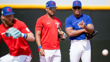 Andy Ibanez Works On Ground Ball Training Exercise With Texas Rangers  Coaches