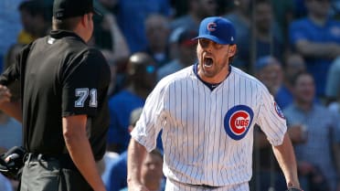 Chicago Cubs starting pitcher John Lackey (41) warms his hands against the  Los Angeles Dodgers during