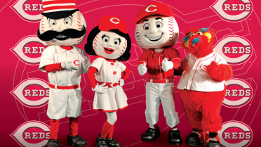 The Cincinnati Reds mascot Mr. Redlegs sits in the dugout during