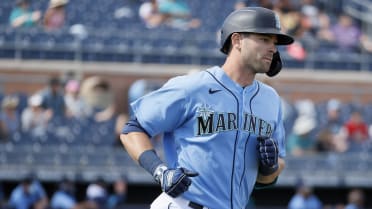 Seattle Mariners' Mitch Haniger, right, is greeted by Ty France