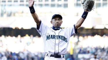 Former Seattle Mariners player Ichiro Suzuki poses with the trophy during a  ceremony honoring Suzuki with the franchise achievement award before the  Major League Baseball game at T-Mobile Park on September 14