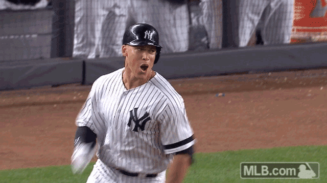 Aaron Judge yells and smiles