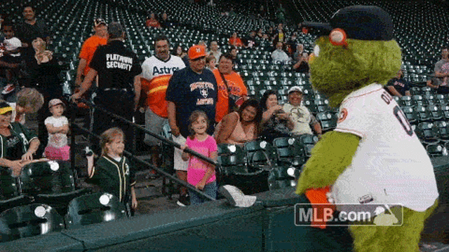 A young fan waits for Houston Astros mascot Orbit to take the