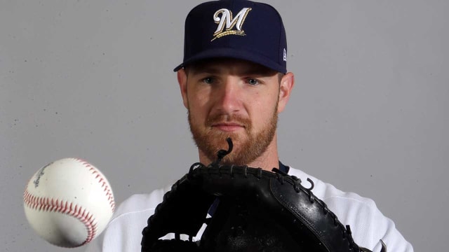 Catcher Jett Bandy of the Milwaukee Brewers sets to throw to first