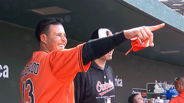 Machado points at Schoop after his second homer of the game.