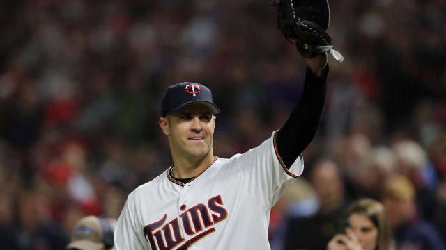 Minnesota Twins catcher Joe Mauer #7 catches a foul ball close to the wall  making the 3rd and final out of the 9th inning in the Twins' baseball game  against the Cleveland