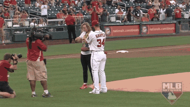 Ledecky hands Harper medals before first pitch