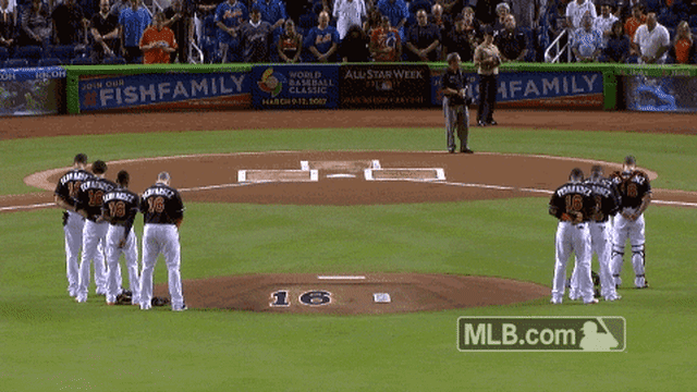 Marlins players surround the mound