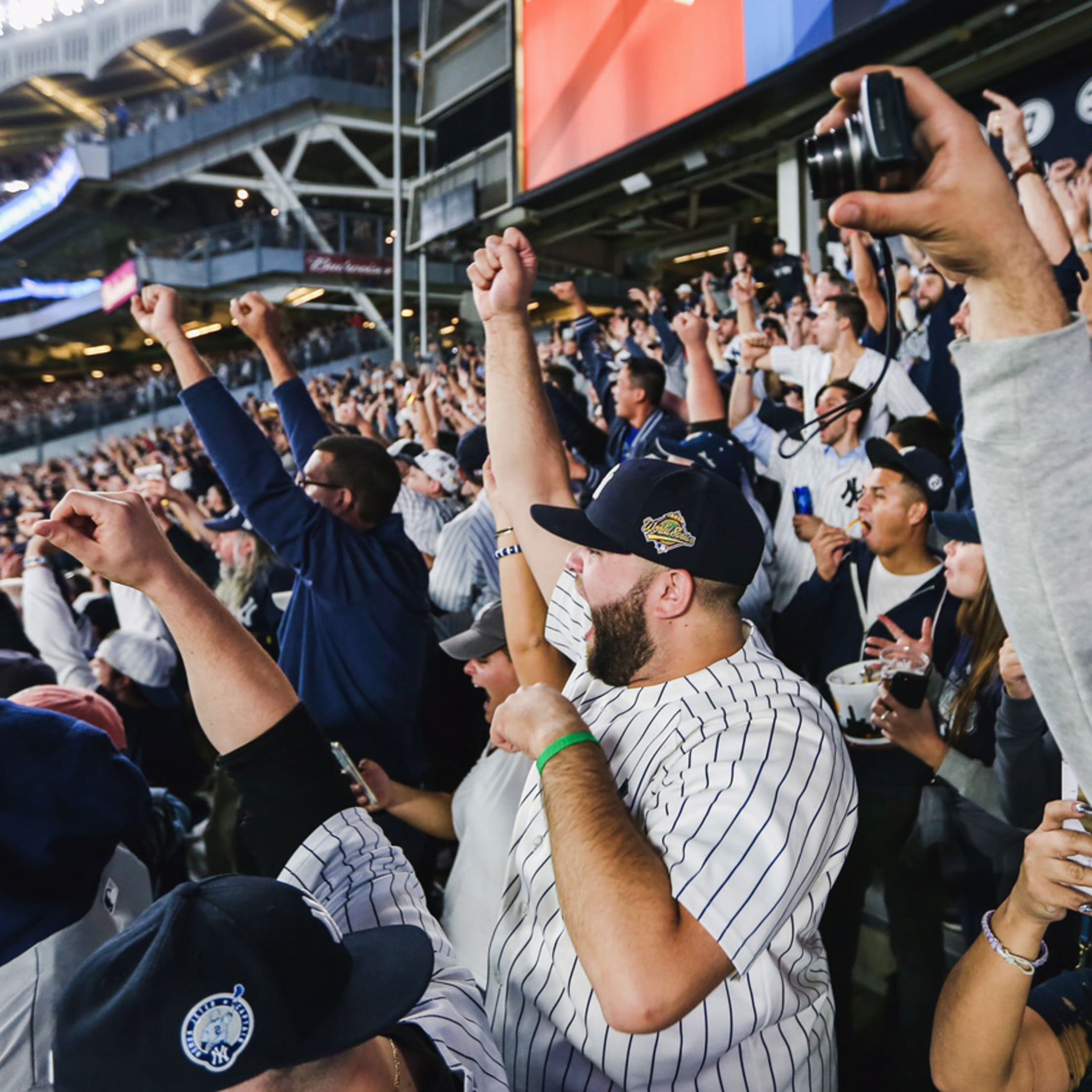 Yankees fans take pictures in the Yankees Museum before the New York Yankees  play the Cleveland Indians in the first regular season game at the new Yankee  Stadium in New York City