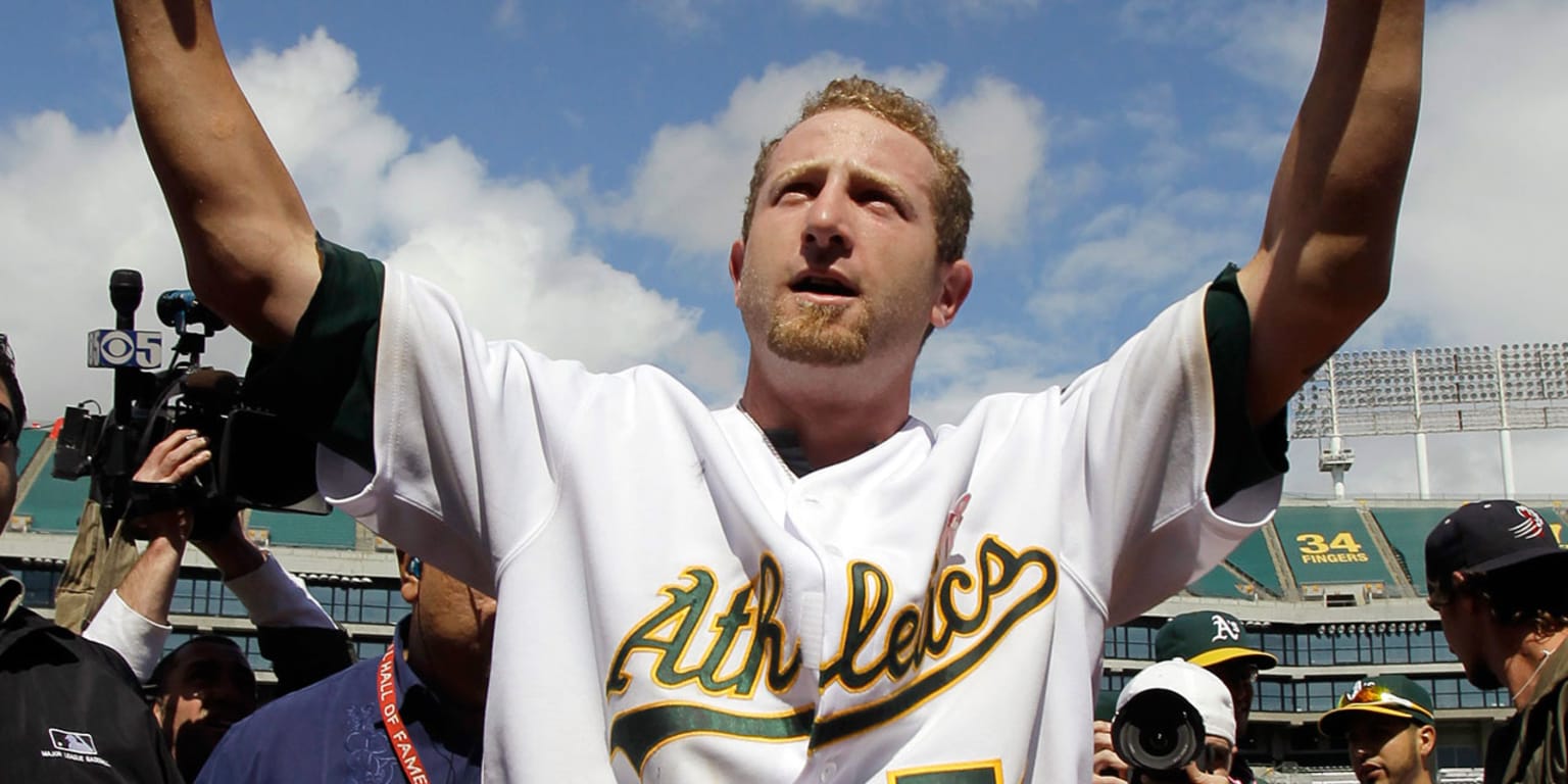 Former Oakland Athletics pitcher Dallas Braden wears a jersey of