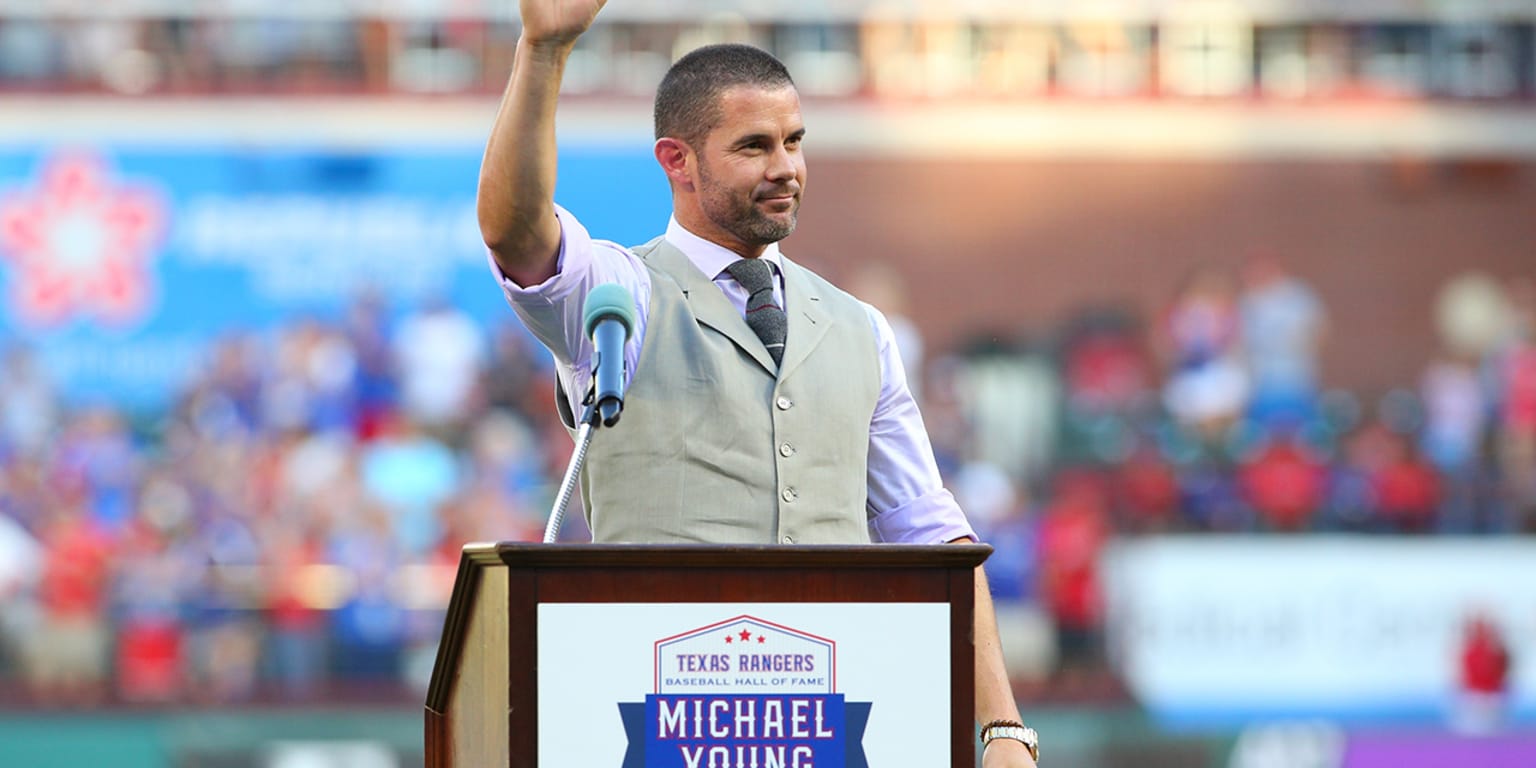 Former Texas Rangers' Michael Young, sits by his wife Cristina