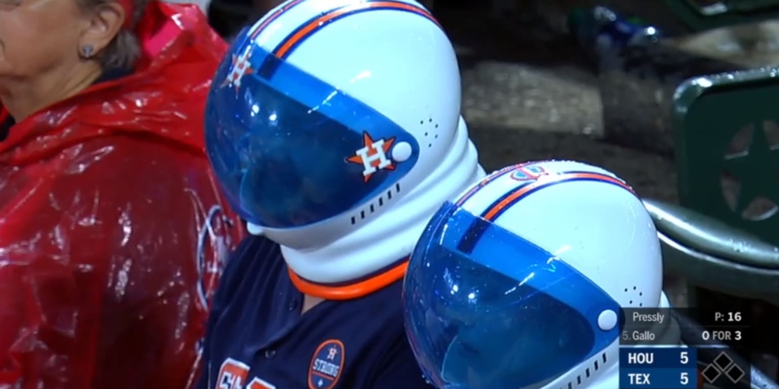 Astros fans wear space helmets behind the plate î€€MLBî€.com