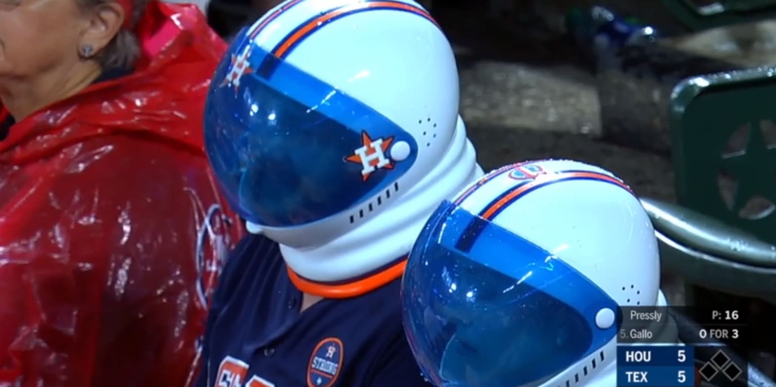 Houston Astros fans dressed up with astronaut helmets watch