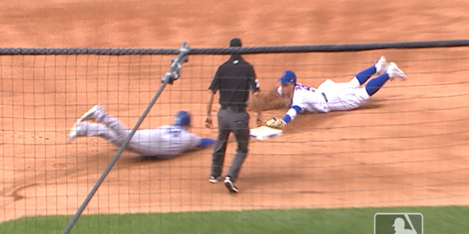 Chicago Cubs' Javier Baez, left, slides into second base safely as he hit a  one-run double as Colorado Rockies second baseman DJ LeMahieu (9) makes a  late tag during the eighth inning