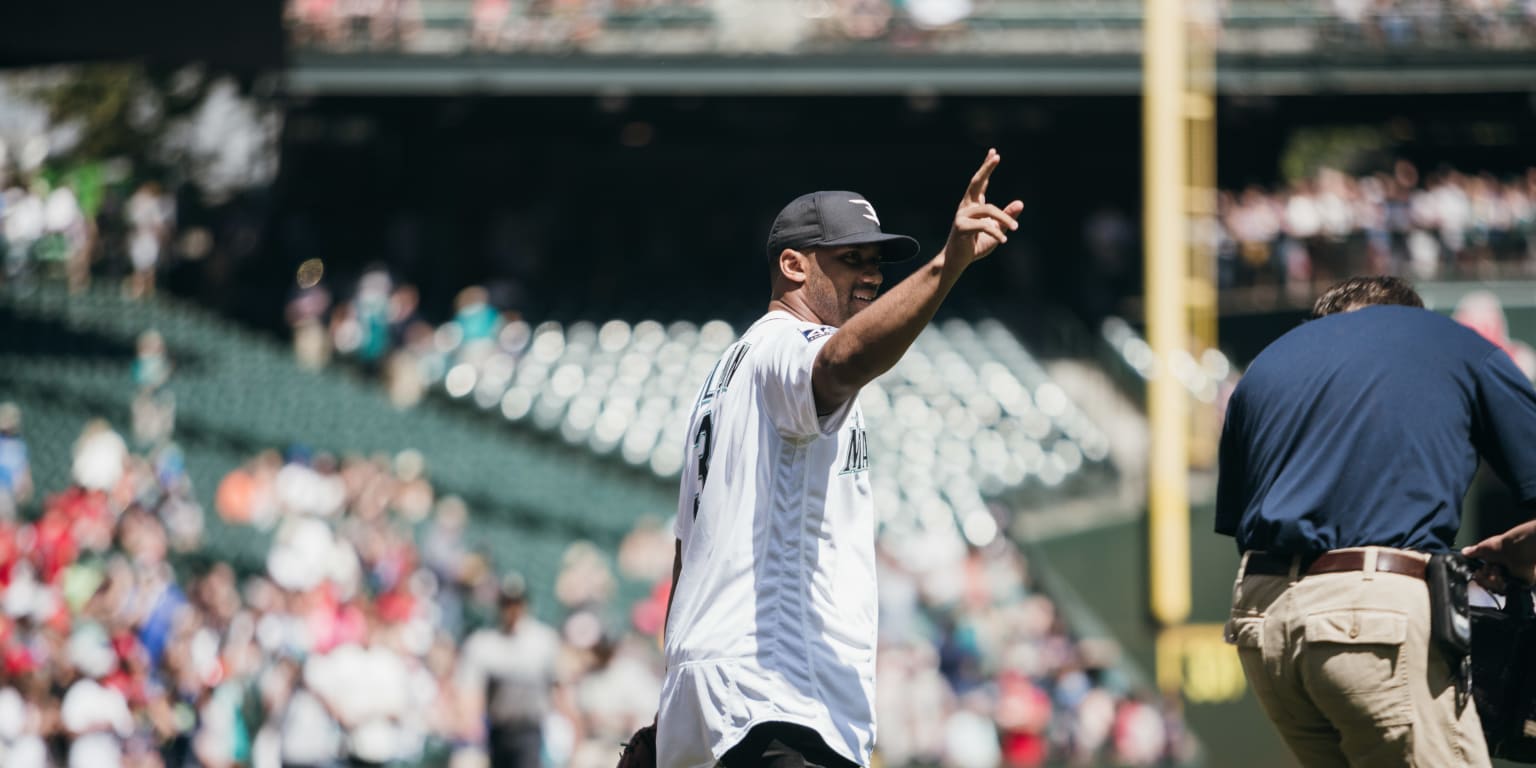 Watch Russell Wilson Throw Out The First Pitch Before Tuesday s 